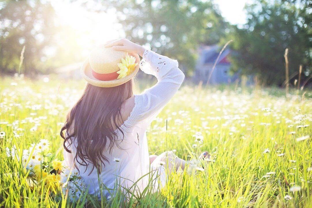 Spring woman in sunny field